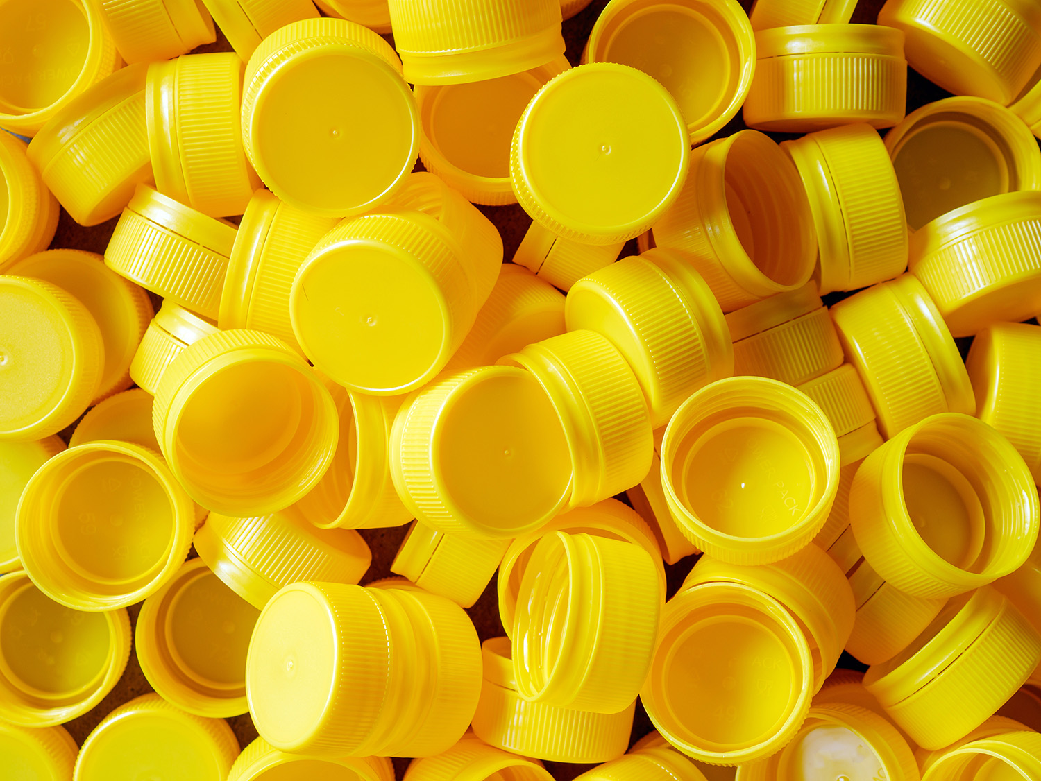 A pile of yellow bottle caps.