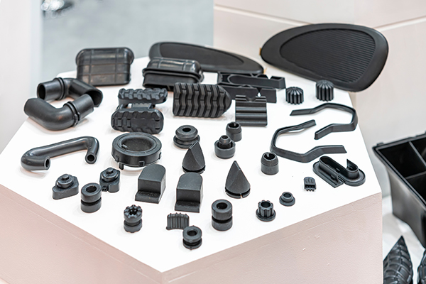 Various rubber molded parts for automotive engines arranged in a display