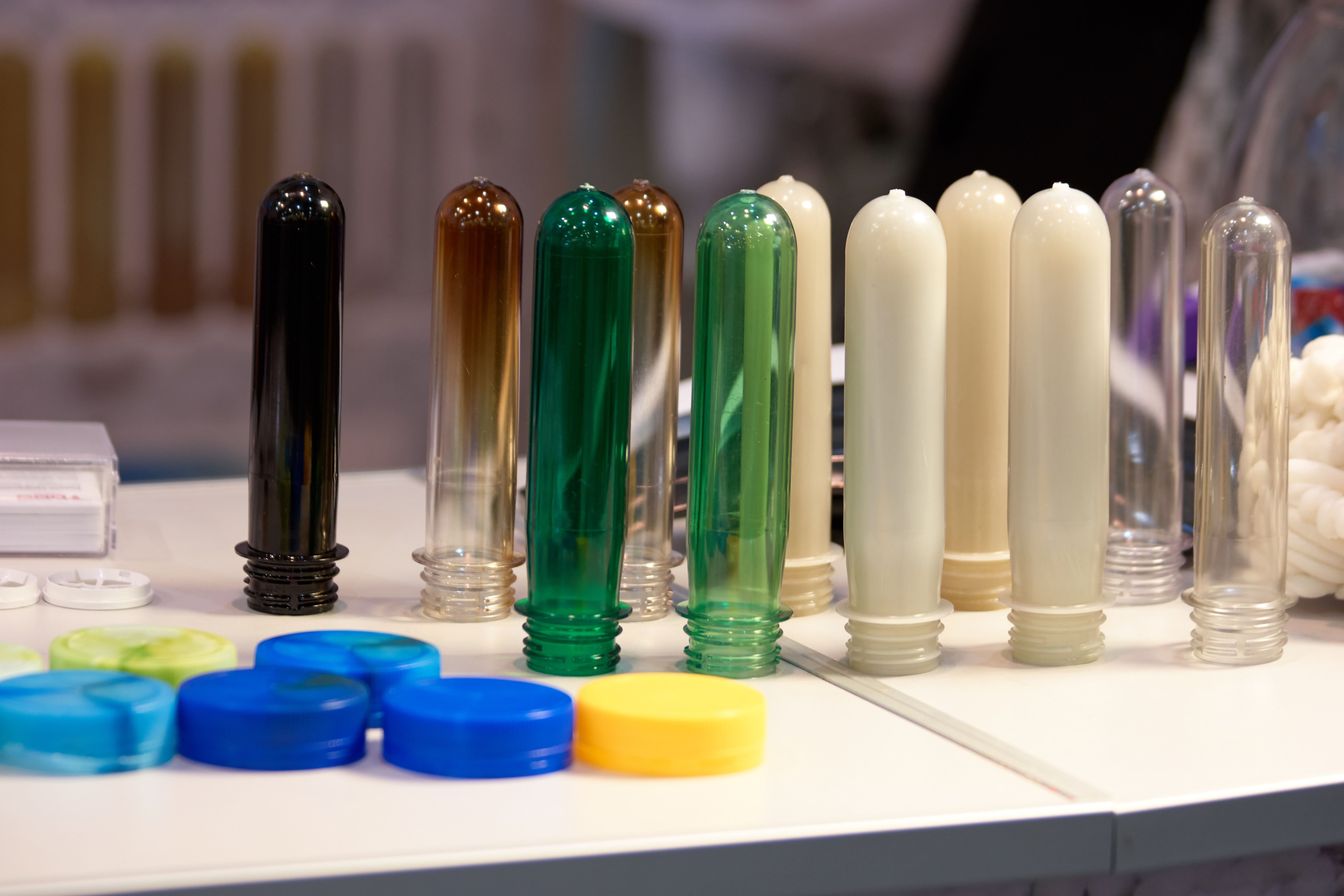 Several pre-blow molding bottles were gathered and displayed. Some are clear, others opaque.