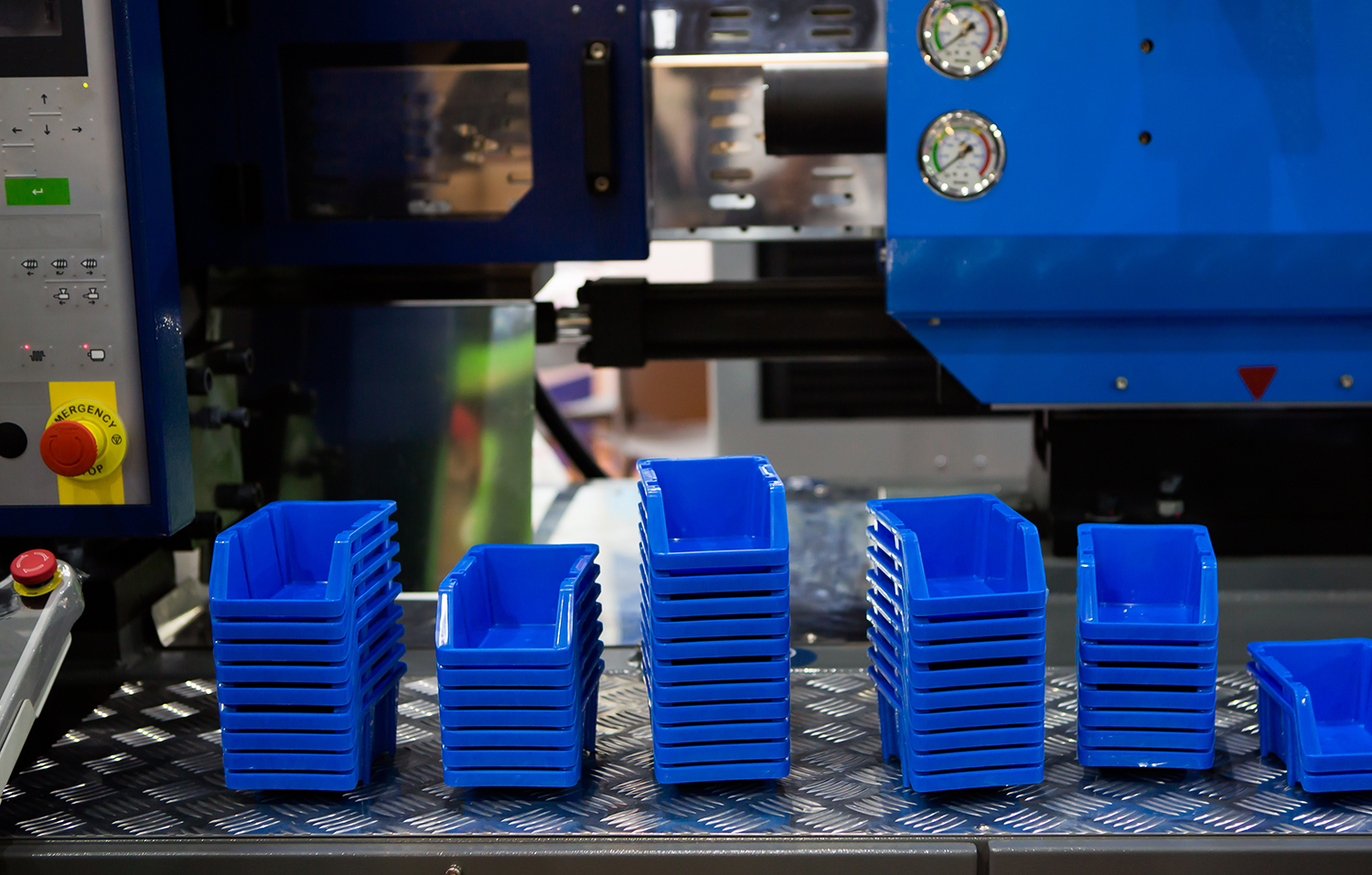 blue plastic containers on a shelf after having been made