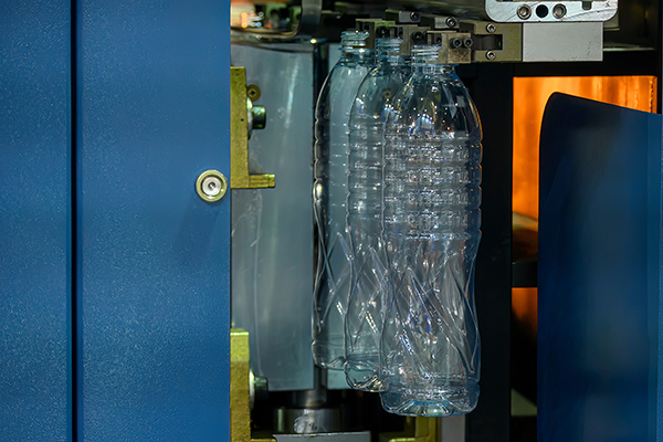 Plastic bottles held in a blow molding machine