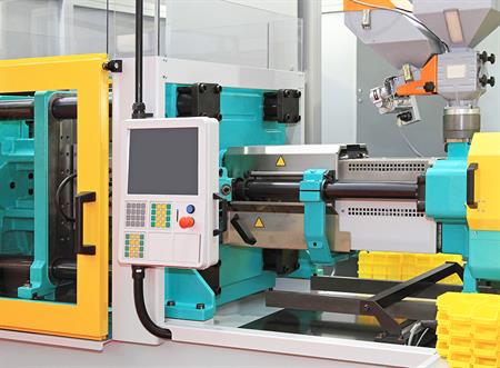 A teal and yellow injection molding machine.